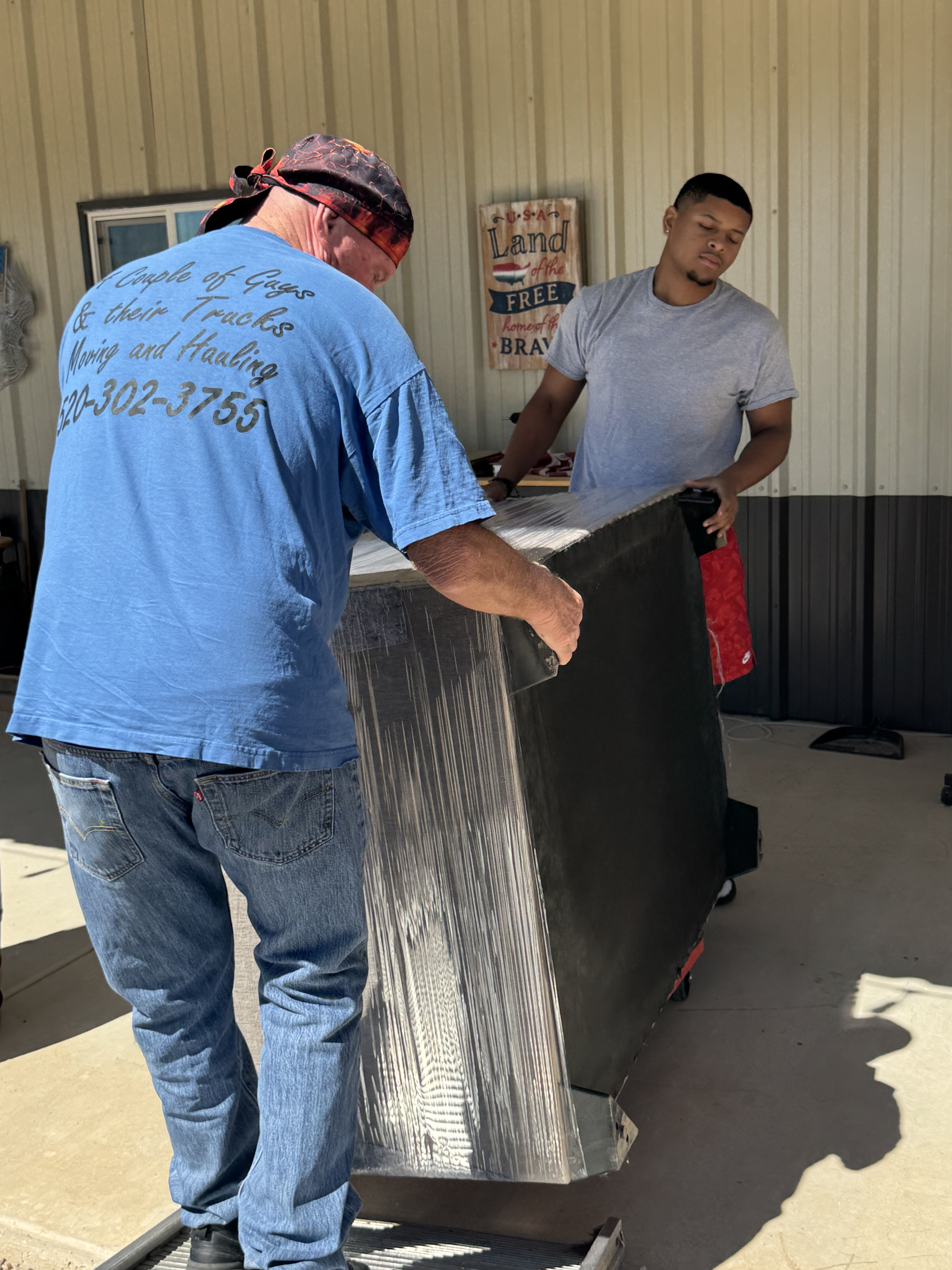two of our Employees hauling a couch